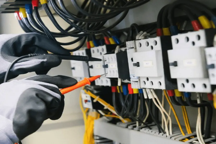Electrician checking connections in an electrical panel