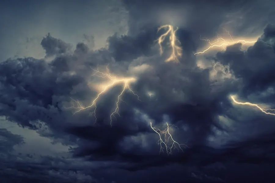 Lightning forking through dark storm clouds